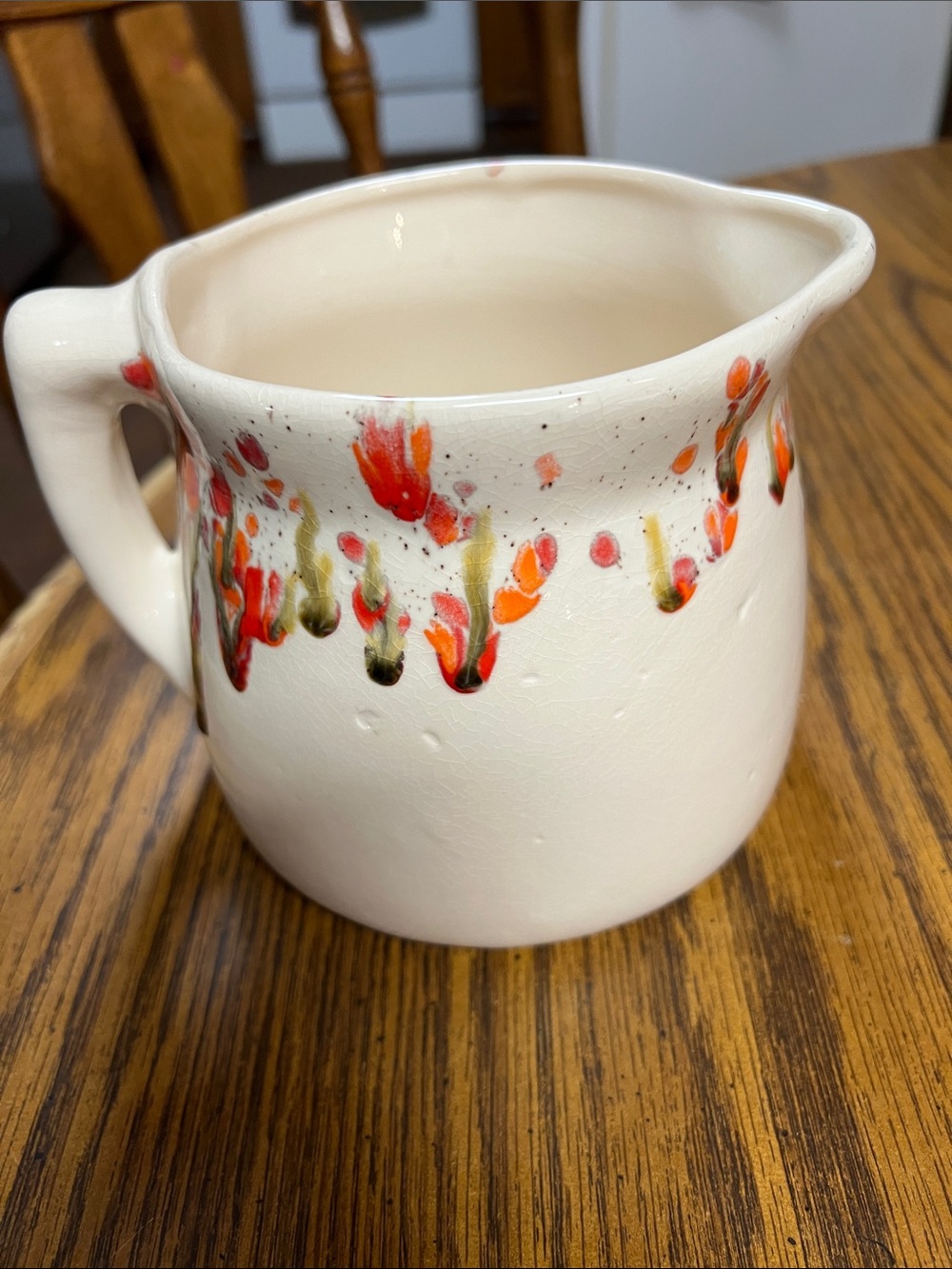 Hand Crafted Cream Ceramic Pitcher with Red and Green Floral Drips